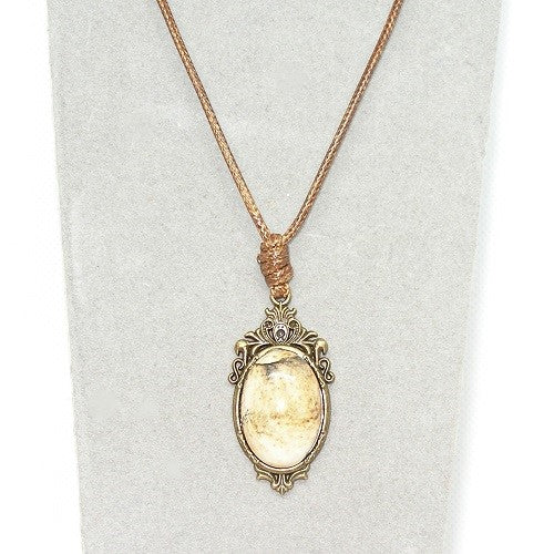 Necklace with a pendant featuring a tan stone on a white background