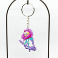 Keychain with cartoon skull inside a pink flower on a white background