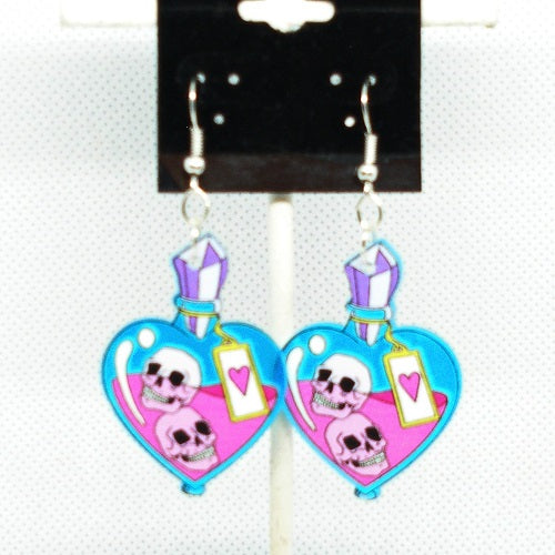 Heart-shaped earrings with skull designs on a display card.