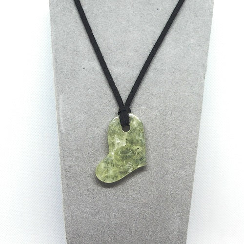Necklace with a green Heart pendant on a gray card