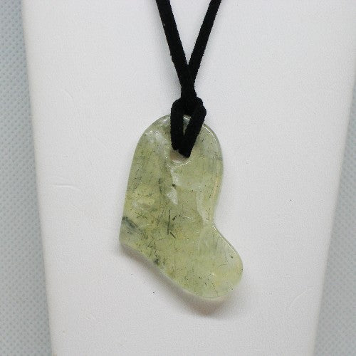 Green stone heart pendant on a black cord against a white background