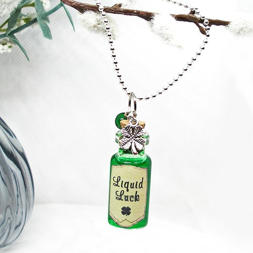 Necklace with a bottle pendant labeled 'Liquid Luck' on a white background