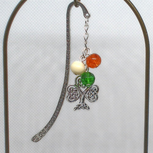 Decorative bookmark with Celtic knot design and colored beads on a white background