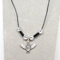 Necklace with a silver bat pendant on a gray background