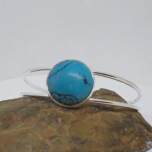 Turquoise stone bracelet on a textured surface
