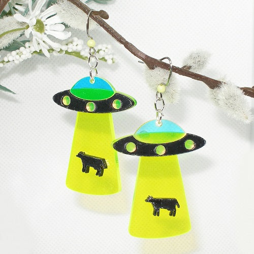  UFO earrings with green and black details on a white background