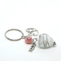 Keychain with heart-shaped charm, pink bead, and silver accents on a white background