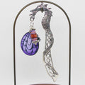 Decorative dragon bookmark with purple and red accents on a white background