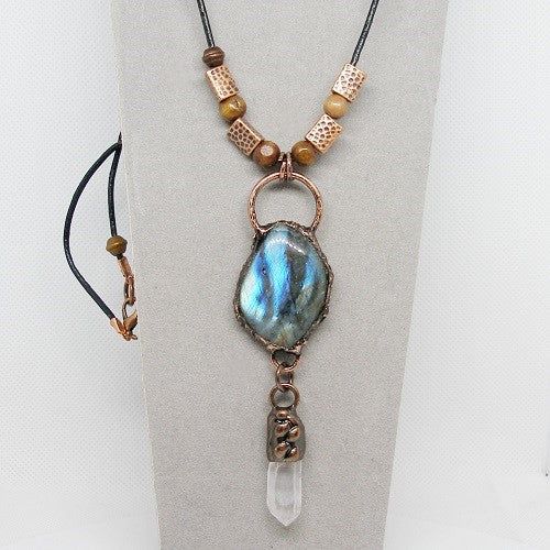 Necklace with a blue pendant and copper beads on a gray background
