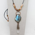 Necklace with a blue pendant and copper beads on a gray background