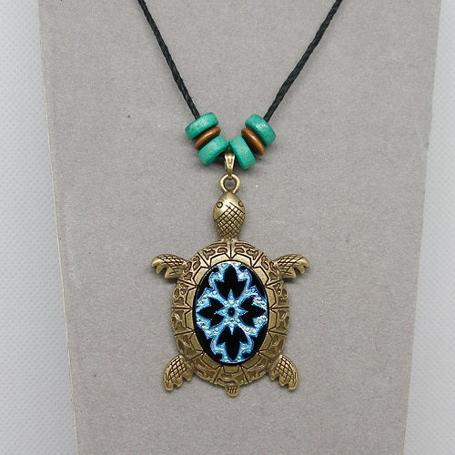 Necklace with a turtle pendant featuring a blue cabochon on a gray background