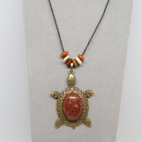 Necklace with stone turtle pendant and colorful beads on a gray background